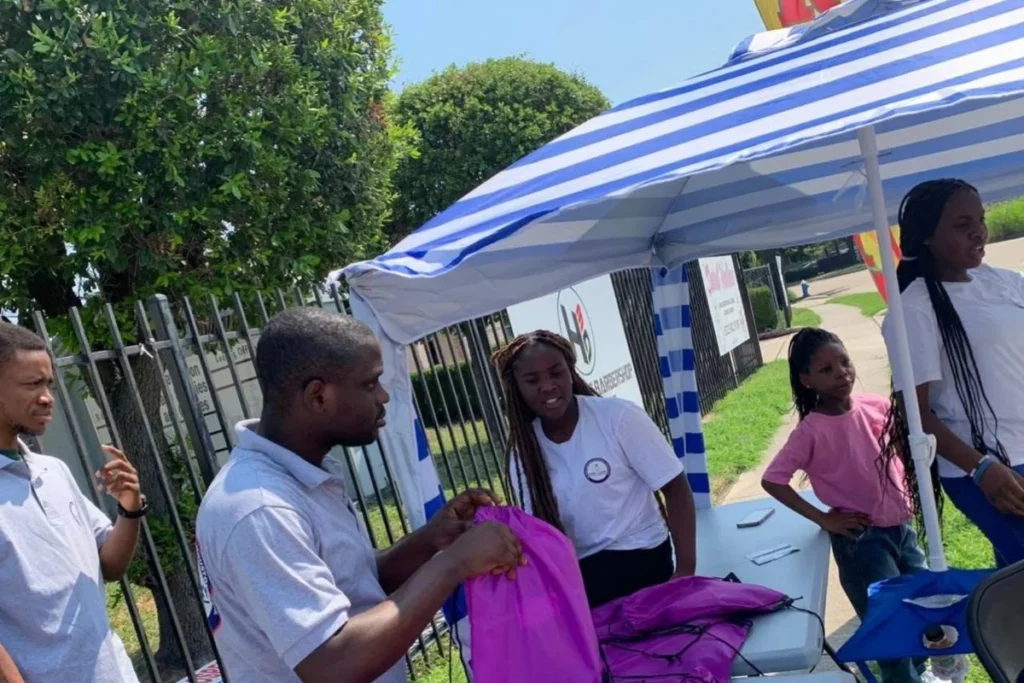 Volunteers handing out school bags at the Back-to-School outreach