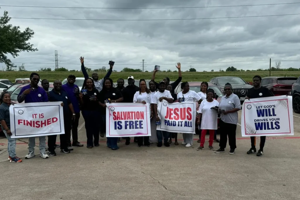 Church members holding Gospel signs during an evangelism outreach in Houston