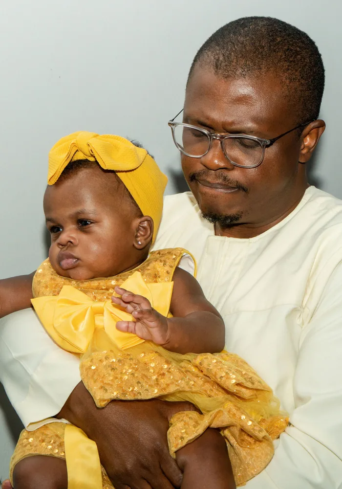 Father holding his baby daughter at church